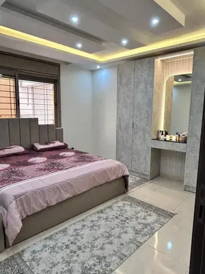 a bedroom with a large bed and a mirror at Irbid in Nāţifah