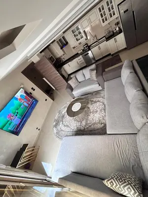 an overhead view of a living room with a television at Irbid in Nāţifah