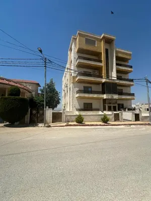 an empty street in front of a building at Irbid in Nāţifah