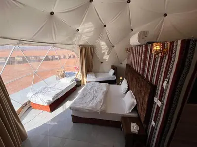 a room with two beds in a tent at Golden Dunes Camp Wadi Rum in Wadi Rum