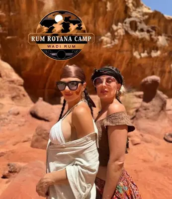 two women standing next to each other in the desert at WADi RUM ROTANA BUBBLE lUXURY CAMP in Wadi Rum
