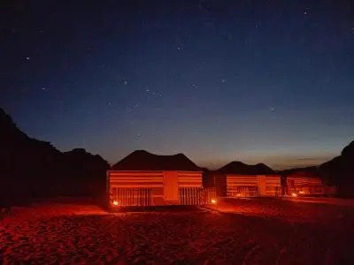 a cabin at night with its lights on at Bedouin Whispers Camp wadirum in Wadi Rum