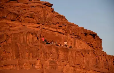 a group of people standing on top of a mountain at Bedouin Whispers Camp wadirum in Wadi Rum