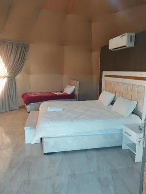 a bedroom with two beds in a room at Essam in Wadi Rum