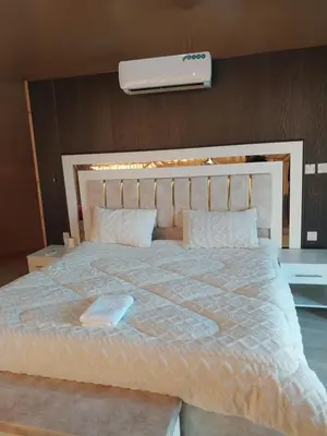 a bedroom with a large bed with a white comforter at Essam in Wadi Rum