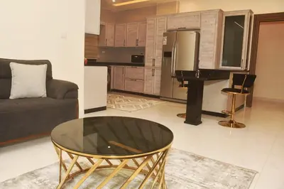 a living room with a couch and a glass table at شقة مفروشة مع ساحة خارجية قرب دوار اليوسفي in Irbid