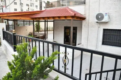 a balcony of a building with a gazebo at شقة مفروشة مع ساحة خارجية قرب دوار اليوسفي in Irbid