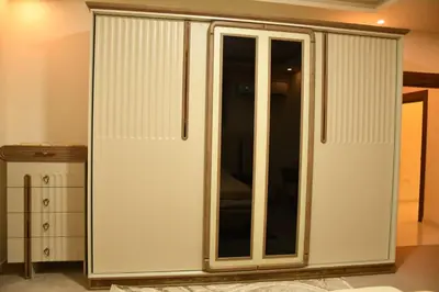 a white cabinet with glass doors in a room at شقة مفروشة مع ساحة خارجية قرب دوار اليوسفي in Irbid