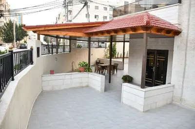 a patio with a pavilion on the side of a building at شقة مفروشة مع ساحة خارجية قرب دوار اليوسفي in Irbid
