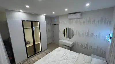 a bedroom with a bed and a sink and a mirror at Modern Apartment in Um Uthaina Amman in Amman