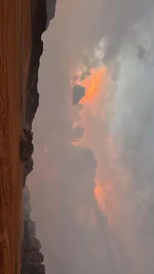 a view of a cloudy sky from a window at Wadi Rum Royal Camp in Disah