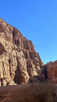 a rocky mountain with a blue sky in the background at Wadi Rum Royal Camp in Disah