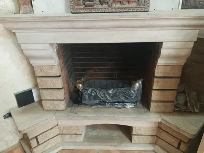 a brick fireplace with a black at غبار الطلح هاوس in Ma‘ān