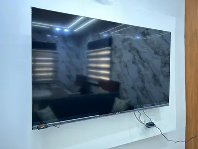 a large flat screen tv hanging on a wall at الكرك الثنية in Kerak