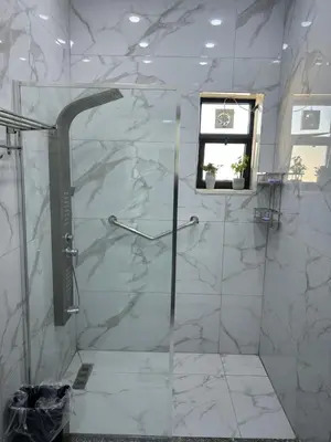 a bathroom with a shower with a glass door at golden apartment - karak in Kerak