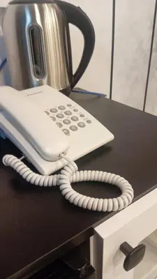 a landline phone sitting on top of a desk at منتجع وأكواخ غصن in Al Jafr
