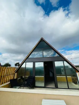 a house with glass windows on the roof at The Branch Lodges in Ajloun
