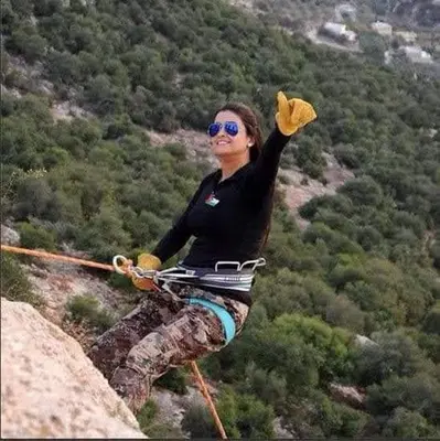 a woman is standing on top of a mountain at The Branch Lodges in Ajloun