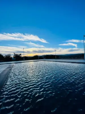 a large pool of water with the sky in the background at The Branch Lodges in Ajloun