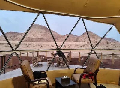a room with a view of the desert from a tent at Sultan Camp Wadi Rum in Wadi Rum