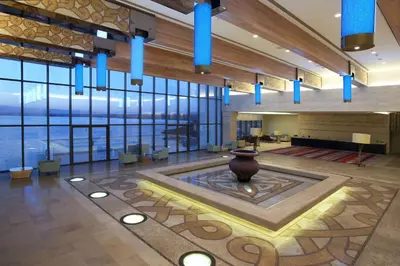 a lobby with a vase in the middle of a room at Hilton Dead Sea Resort & Spa in Sowayma