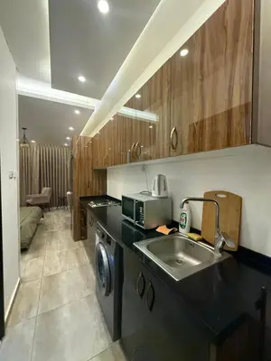 a small kitchen with a sink and a microwave at Swefieh studio 8 in Amman