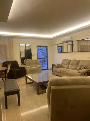 a living room with couches and a coffee table at Khalda apartment in Amman