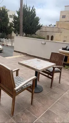 two chairs and a table and a table and chairs at Khalda apartment in Amman