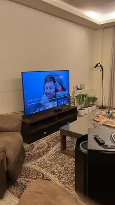 a living room with a large flat screen tv at Khalda apartment in Amman