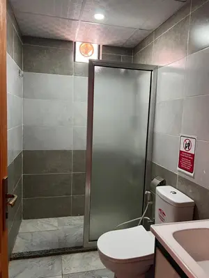 a bathroom with a shower and a toilet and a sink at Golden Stars Luxury Camp Wadi Rum in Wadi Rum