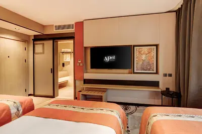 a hotel room with two beds and a flat screen tv at April Hotel in Aqaba