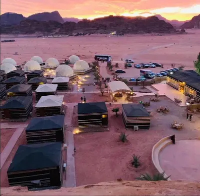 a group of tents in the desert at sunset at Nile Bedouin Camp in Disah