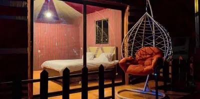 a bedroom with a bed and a swing at Nile Bedouin Camp in Disah