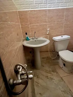 a bathroom with a sink and a toilet at Lozi House Cozy Stay in Al Azraq ash Shamālī