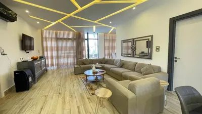 a living room with a couch and a table at Villa W2 in Amman