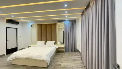 a bedroom with a large bed and a window at Villa W2 in Amman