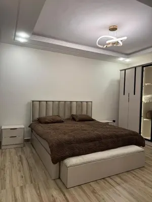a bedroom with a large bed and a ceiling at Luxury apartment شقة فخمة in Amman