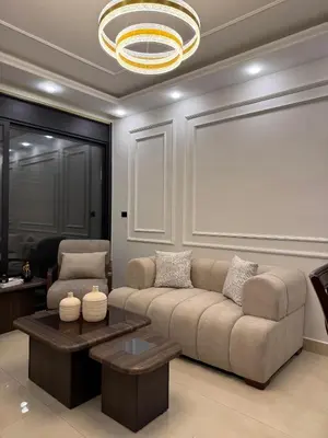 a living room with a couch and a chandelier at Luxury apartment شقة فخمة in Amman