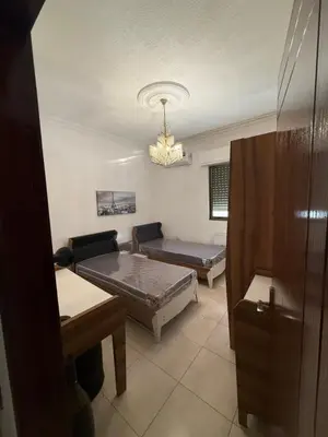 a living room with two beds and a couch at Furnished luxurious apartment with a stunning view near Kling Hussein Business Park in Amman