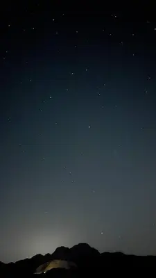 a night sky filled with stars and a mountain at Siella Pearl of Wadi Rum in Wadi Rum