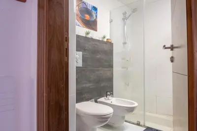 a bathroom with a toilet and a sink at Weibdeh Oasis 2 Bedroom in Amman