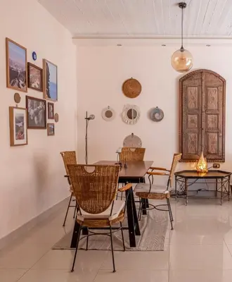 a dining room with a table and chairs at Weibdeh Oasis 2 Bedroom in Amman