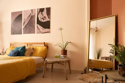 a bedroom with a bed and a mirror at Weibdeh Oasis 2 Bedroom in Amman