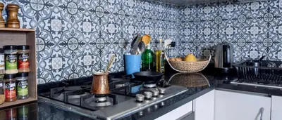 a kitchen with a stove and a counter top at Weibdeh Oasis 2 Bedroom in Amman