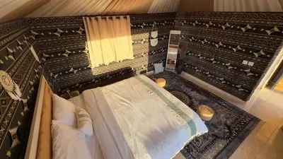 an overhead view of a room with a bed and a window at Wadi rum camp Ausama in Wadi Rum