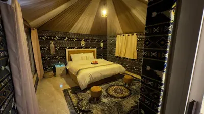 a bedroom with a bed in a tent at Wadi rum camp Ausama in Wadi Rum