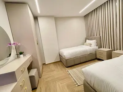 a small bedroom with a bed and a mirror at شقة فندقية فاخرة في عمان قرب طريق المطار Luxury Living Near Airport Road in Amman