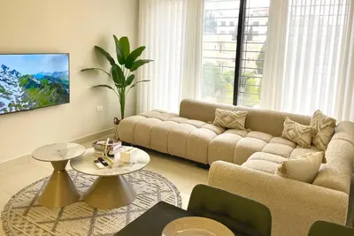 a living room with a couch and a table at شقة فندقية فاخرة في عمان قرب طريق المطار Luxury Living Near Airport Road in Amman
