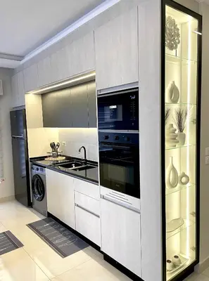 a kitchen with a stove and a sink and a microwave at شقة فندقية فاخرة في عمان قرب طريق المطار Luxury Living Near Airport Road in Amman