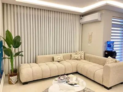a living room with a couch and a table at شقة فندقية فاخرة في عمان قرب طريق المطار Luxury Living Near Airport Road in Amman